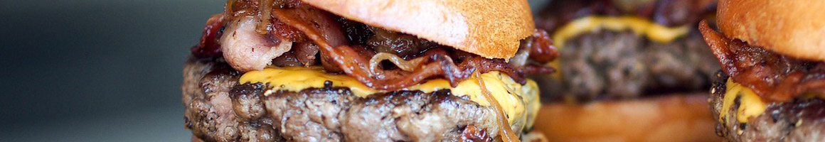 Eating Burger at Jimbo's Hamburger Palace restaurant in New York, NY.